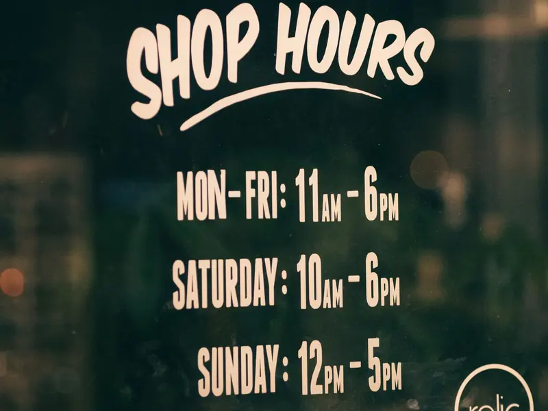 Opening hours in letters on a window