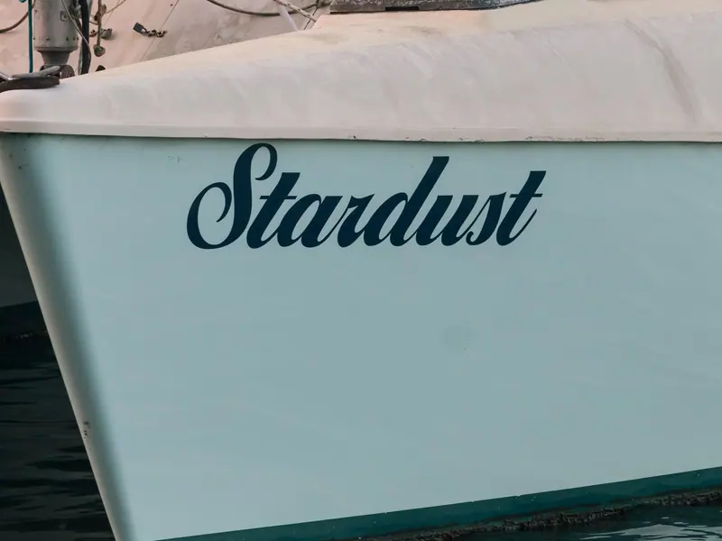 The name Stardust on the hull of a sailing boat